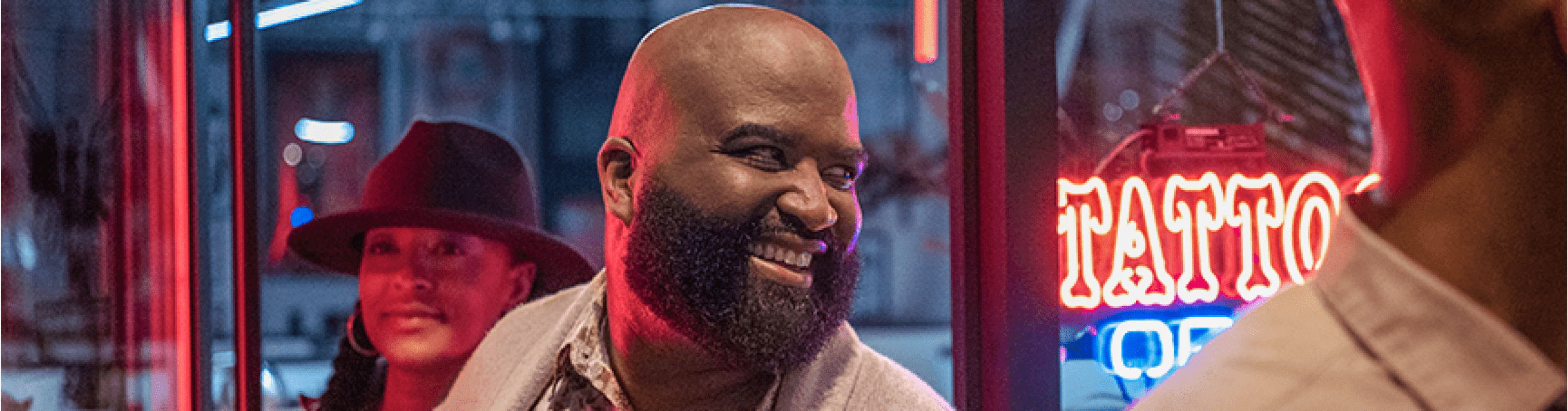 Phil and others are entering a tattoo parlor.